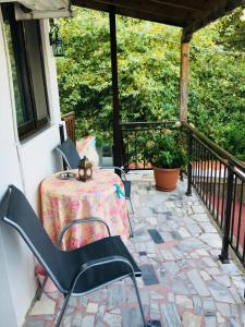 a patio with a table and chairs on a balcony at AVRA Apartments in Therma