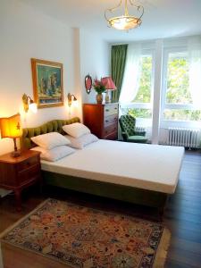 a bedroom with a large bed and a rug at Light, Spacious Apartment in the Heart of Belgrade in Belgrade