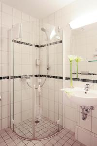 a bathroom with a shower and a sink at Boulevard Hotel Altstadt Schwerin in Schwerin