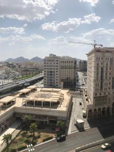 an aerial view of a city with buildings and a crane at Manazel Alaswaf Hotel in Al Madinah