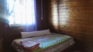 a small bed in a room with a window at Morada das Pedras Recanto da Paz in Piçarras +49 photos