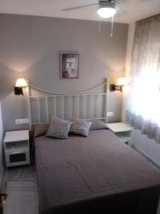 a bedroom with a bed with two pillows on it at Apartamento Rio Marinas Nerja 46 in Nerja