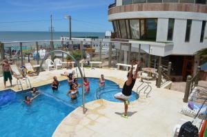 a group of people in a swimming pool at Complejo Turístico CapArcona in Villa Gesell