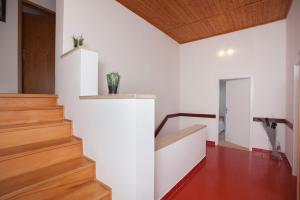 a staircase in a house with white walls and wooden floors at Apartment Relax in Fažana