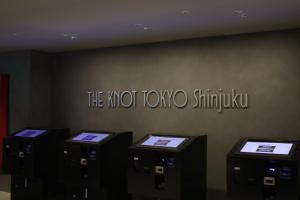 a sign that says the not tokyo singkok on a wall at THE KNOT TOKYO Shinjuku in Tokyo