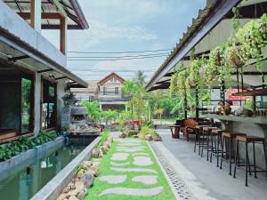 an outdoor patio with a pool and tables and chairs at Baan Sala Lung Dam - Fisherman Village in Bophut