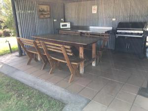 a kitchen area with a table and chairs at Tuckerbox Motor Inn in Gundagai