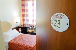 A bed or beds in a room at Antico Albergo Madonna