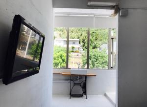 a room with a table in front of a window at Mayhow Donghe in Donghe