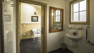 a bathroom with a sink and a mirror at Waitaki Braids in Kurow