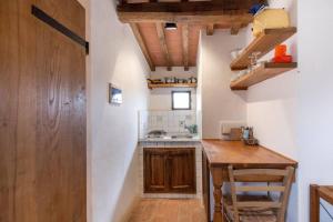 a small kitchen with a wooden counter and a table at Montefili in Greve in Chianti