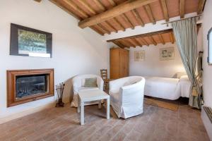 a bedroom with a bed and a fireplace at Montefili in Greve in Chianti