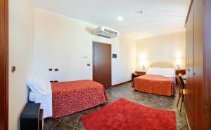 A bed or beds in a room at Antico Albergo Madonna