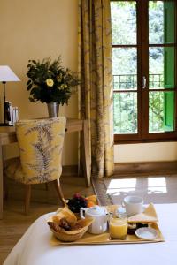 a table with a basket of food and a vase of flowers at Le Grand Hôtel in Moltig les Bains