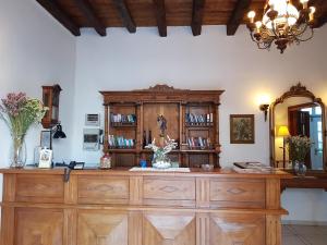 a large wooden dresser in a room with a mirror at Ippokampos in Hydra