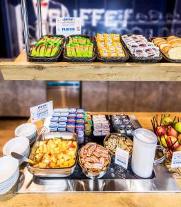 a display case in a bakery with different types of food at ibis budget Antony Massy rénové 2024 in Antony