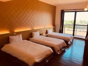 Postel nebo postele na pokoji v ubytování Taroko Inn