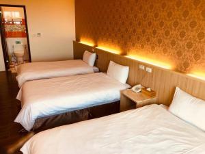 Postel nebo postele na pokoji v ubytování Taroko Inn
