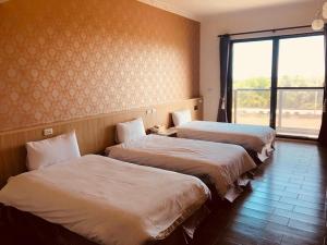 Postel nebo postele na pokoji v ubytování Taroko Inn