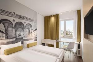 a bedroom with a bed and a desk and a television at Super 8 by Wyndham Munich City North in Munich +37 photos