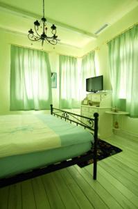 
Un pat sau paturi într-o cameră la Arcadia Hotel - Marina Regia Residence

