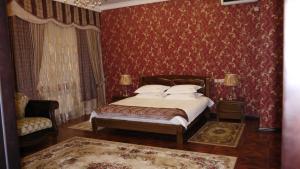 a bedroom with a bed and a dresser at Gostinitsa Victoriya in Orenburg