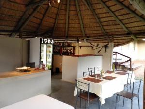 a tasting room with a white table and chairs at Chobe Sunset Chalets in Lesoma