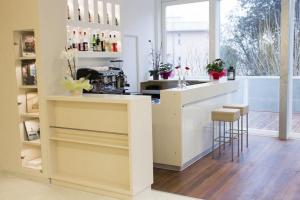 a kitchen with a counter and stools in a room at My Hotel in Gabicce Mare