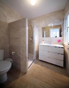 a bathroom with a toilet and a sink and a shower at Hotel Casa Rosa in Benalmádena