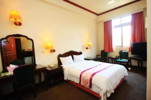 Postel nebo postele na pokoji v ubytování East Commercial Affairs Hotel