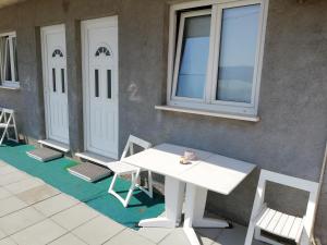 a white table and chairs in front of a building at Studio Apartment Sanja 2 in Neum +3 photos