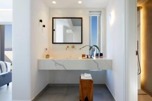 a bathroom with a sink and a mirror at Phos The Boutique in Akrotiri