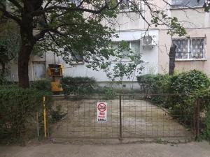 a gate with a no smoking sign in front of a house at Casa Mirage in Craiova