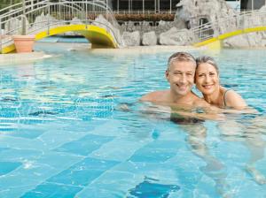 Ein Mann und eine Frau im Schwimmbad. in der Unterkunft Johannesbad Hotel Füssinger Hof in Bad Füssing