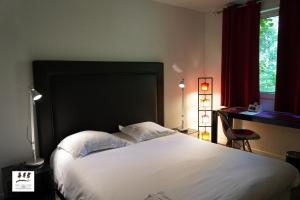 A bed or beds in a room at Enzo Hôtels Premier Prix - Logis Amnéville