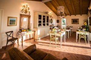 a living room with a couch and a table and chairs at Podere Zampiera Vecchia in Imola