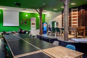 a ping pong table in a room with green walls at Motion Chueca in Madrid