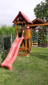 a playground with a slide in the grass at Chalupa Majer Biffar in Dunajský Klátov