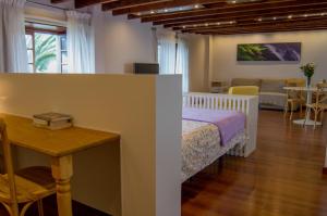 a bedroom with a bed and a table and a dining room at Apartamento en Santa Cruz de La Palma in Santa Cruz de la Palma