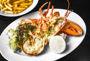 a plate of food with a lobster and french fries at Dakota Glasgow in Glasgow