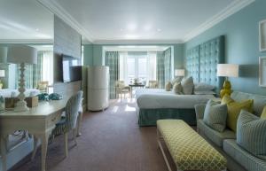 a hotel room with a bed and a living room at Roslin Beach Hotel in Southend-on-Sea