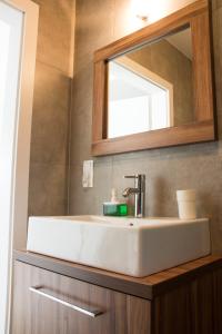 a bathroom with a sink and a mirror at Apartment SUN I in Kołobrzeg