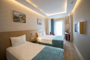 Postel nebo postele na pokoji v ubytování Meretto Hotel LALELİ