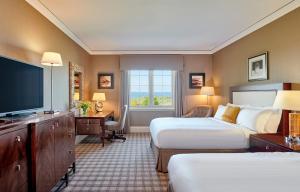 a hotel room with two beds and a television at Fairmont St Andrews, Scotland in St. Andrews