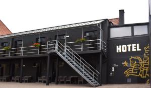 a black hotel with stairs on the side of it at Hotel Brouwerij Het Anker in Mechelen