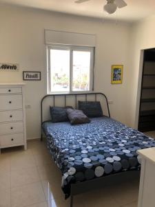 a bedroom with a bed and a window in it at View House in Eilat