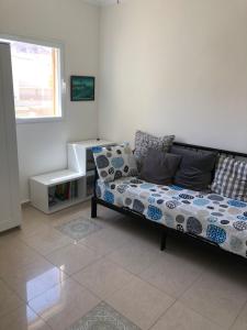 a living room with a couch and a window at View House in Eilat