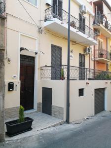 a building with a door and a potted plant on the street at centralcity in Reggio di Calabria
