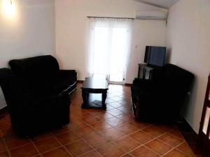 a living room with two chairs and a table at Villa Mirovica in Bar