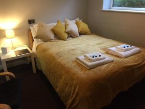 a bedroom with a bed with two towels on it at Tudor Lodge in Scunthorpe